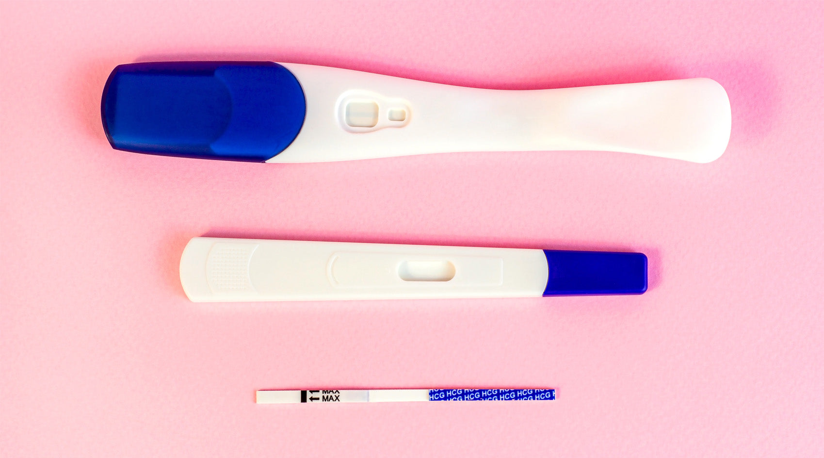 Different types of pregnancy tests, including digital, midstream, and strip tests, displayed on a pink background.