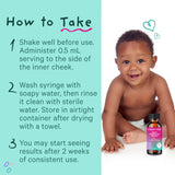 A happy baby sitting next to a bottle of Pink Stork Baby Probiotic Drops. How To Take.
