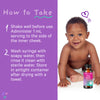 A happy baby sitting next to a bottle of Pink Stork Baby Sleep Drops. How to Take.