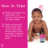 African American baby smiling and sitting behind a bottle of Pink Stork Baby Sleep Drops. Directions on how to take.