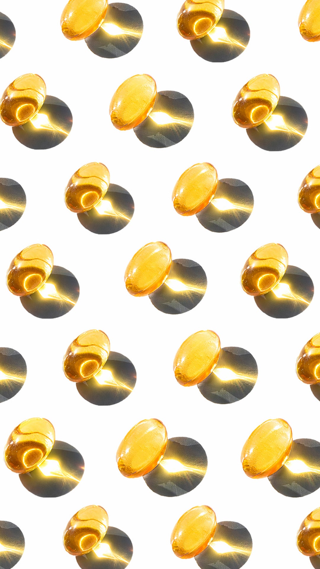 Pattern of yellow pills on a white background