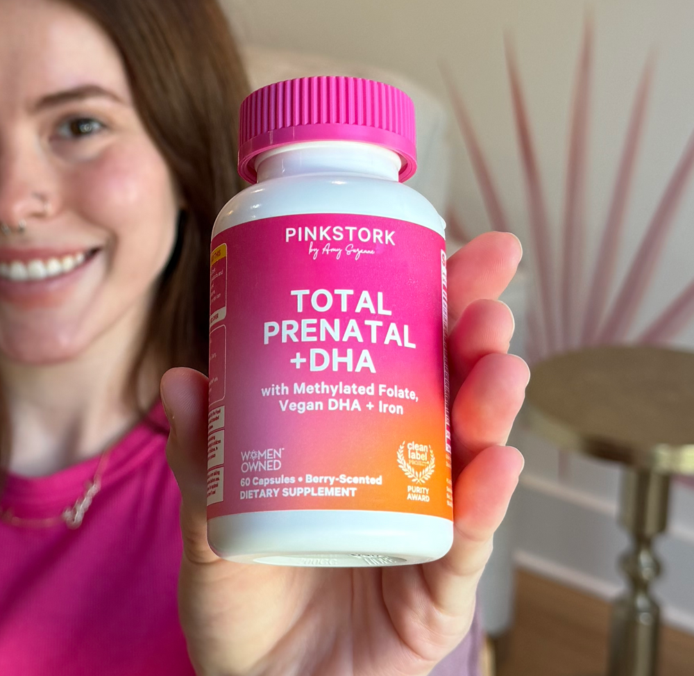 Woman holding total prenatal bottle