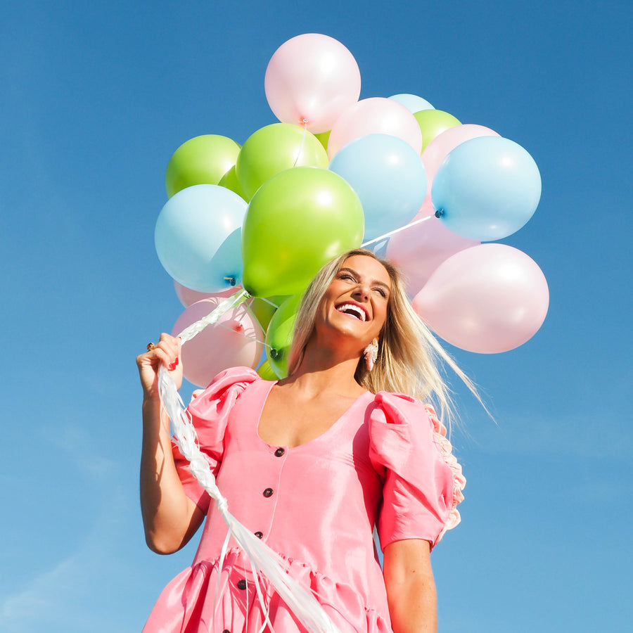 Amy holding colorful balloons