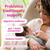 Woman looking down at her baby while it breastfeeds. Probiotics traditionally support digestive wellness, gut + brain connection, and immune health.