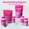 Group of Pink Stork nursing products with capsules spread around them. Breastfeeding support from start to finish.