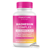 A white bottle of Pink Stork Magnesium Complex dietary supplement with a bright pink cap and a pink-to-yellow label, shown on a white background with two clear capsules in front.