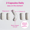 Five vitamin capsules all lined up with the middle one open and spilling out. Two capsules daily. Easy on the stomach. Magnesium, Vitamin D, and Black Pepper Extract.