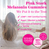 Pink Stork Melatonin Gummies. We put it to the test. cGMP + NSF Certified facility. Based + blended in the USA. Unannounced sampling + testing. Cruelty free. Women sitting in bed stretching facing a window.