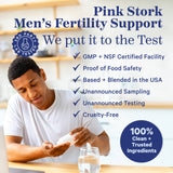 A man pouring capsules into in his hand from a bottle. Pink Stork Men's Fertility Support. 
