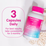 Bottle of Pink Stork 40:1 Ratio Myo + D-Chiro Inositol laying down with capsules spread around it. 3 capsules daily. For best results, take consistently for 3 months.