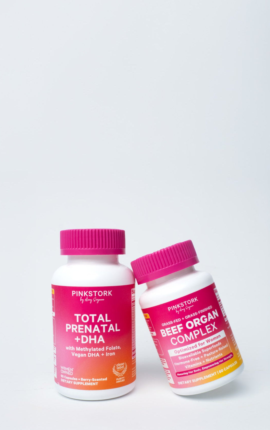 Two supplement bottles labeled 'Total Prenatal + DHA' and 'Beef Organ Complex' by Pink Stork on a white background.