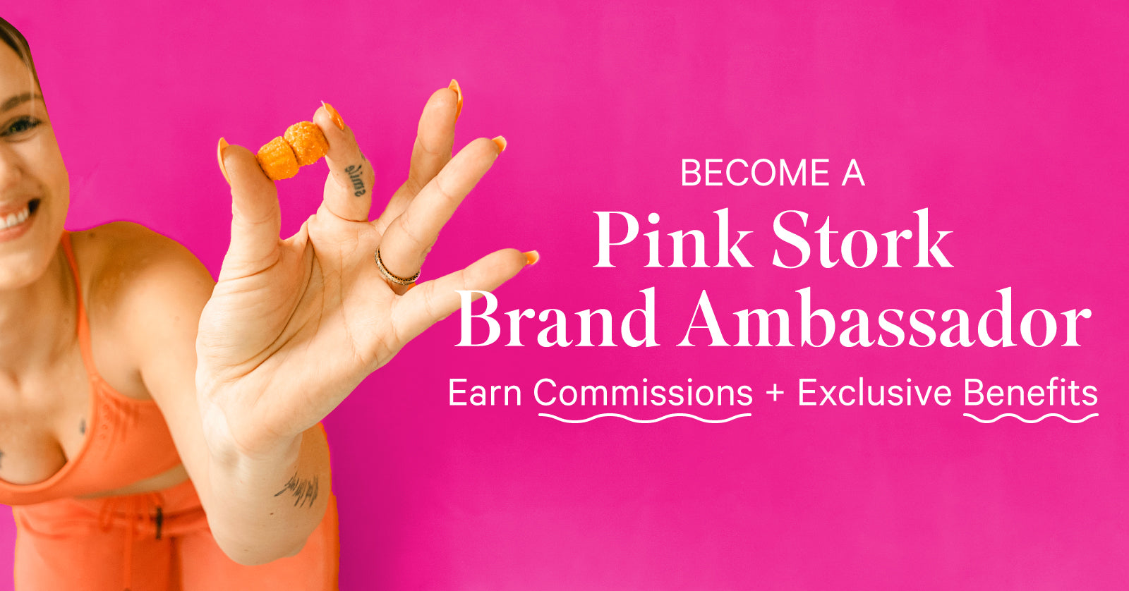 Woman holding 2 orange gummies and smiling. Become a Pink Stork Brand Ambassador - earn commissions + exclusive benefits.