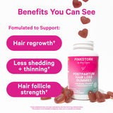 Bottle of Pink Stork Postpartum Hair Loss Gummies with gummies surrounding it and falling into it. Benefits your can see.