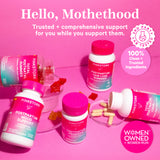 Pink Stork postpartum products spread out with gummies and capsules spilled out around the products. Hello, motherhood - trusted + comprehensive support for you while you support them.