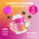 An open bottle of Pregnancy Iron Gummies with individual gummies around the bottle. Powdered closeups of Iron and Vitamin C. Clinically studied ingredients.