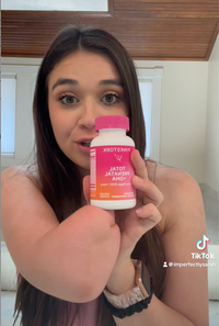 Woman holding a Total Prenatal bottle