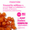 Overhead shot of a pile of orange gummies. Pink Stork - trusted by millions to provide hope and solutions for fertility, pregnancy, postpartum, and nursing.