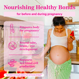 A pregnant woman looking down lovingly at her belly while holding a slice of watermelon. Nourishing Healthy Bonds.