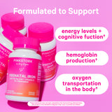 Group of Pink Stork Prenatal Iron bottles leaning against each other. Formulated to support energy levels + cognitive function, hemoglobin production, and oxygen transportation in the body.