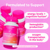 Group of Pink Stork Prenatal Iron bottles leaning against each other. Formulated to support energy levels + cognitive function, hemoglobin production, and oxygen transportation in the body.