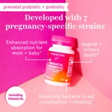 Pink Stork Prenatal Probiotic bottle leaning against pink wall. Developed with 7 pregnancy-specific strains. List of benefits this product provides.