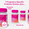 Four bottles of Pink Stork Prenatal Probiotic staggered across the page. 7 pregnancy-specific probiotic strains plus prebiotic fiber and vitamin b6.