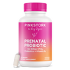 Pink Stork Prenatal Probiotic bottle with capsule leaning against the bottom of the bottle.