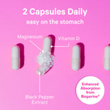 Line of vitamin capsules with the middle one broken open with the contents spilling out. 2 capsules daily - easy on the stomach.