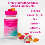 Pink Stork Total Postnatal Gummies bottle with gummies surrounding it. Formulated with clinically studied ingredients. List of ingredients. 