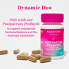 Bottle of Pink Stork Postpartum Probiotic with vitamin capsules spread out next to it. Dynamic duo. Pair with our Postpartum Probiotic.