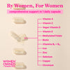 Supplement capsules lined up vertically with the middle on cracked open and spilling out. By women, for women - Comprehensive support in 1 daily capsule. List of ingredients in the capsule.