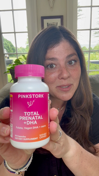 Woman holding a Total Prenatal bottle
