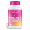 Pink Stork Women's Health Probiotic bottle with capsule leaning against the bottom of the bottle.